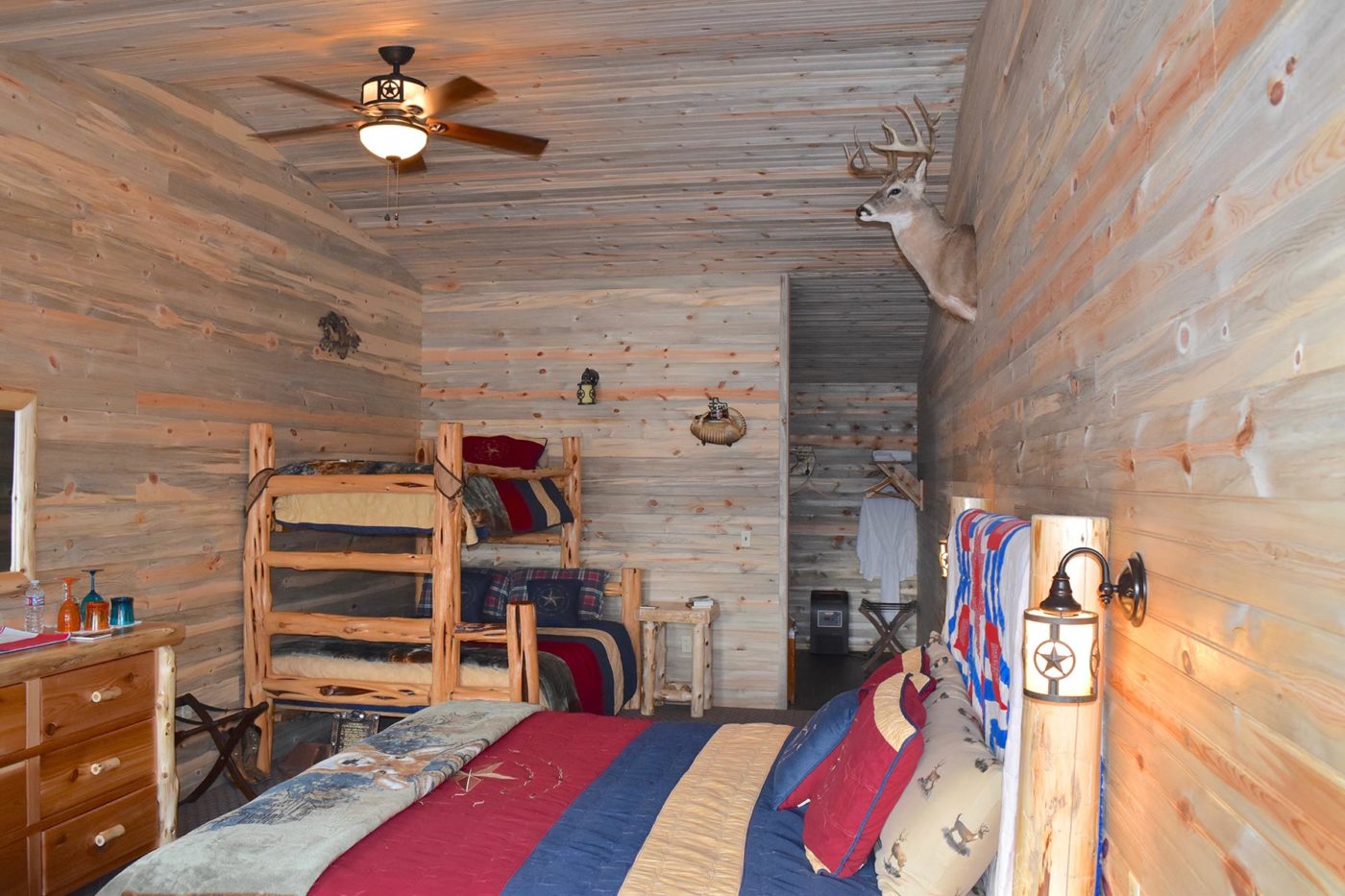 Guest room with queen bed and bunks.
