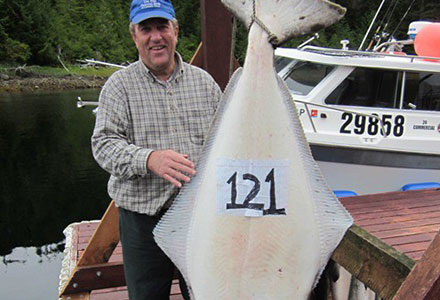 Guests stands next to 121 pound halibut.