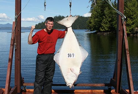 Guest poses with this 109 pound halibut catch.
