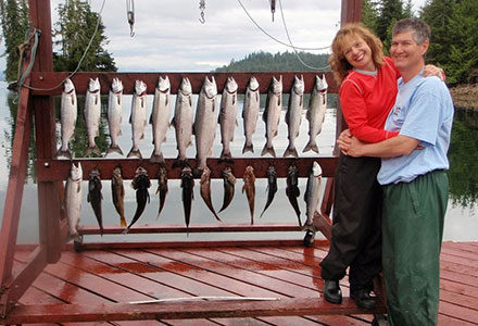 Guest couple pose with their salmon and rockfish catch.