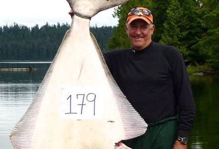 Guest poses with his 179 pound halibut.