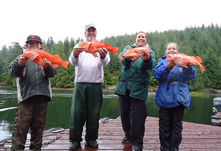 Family holds up their yelloweye rockfish, one each!