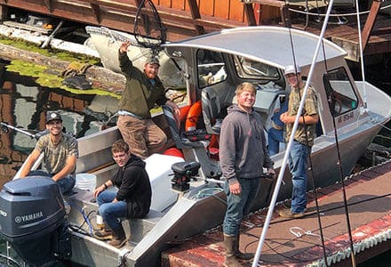 The crew works on one of the docked fishing boats.