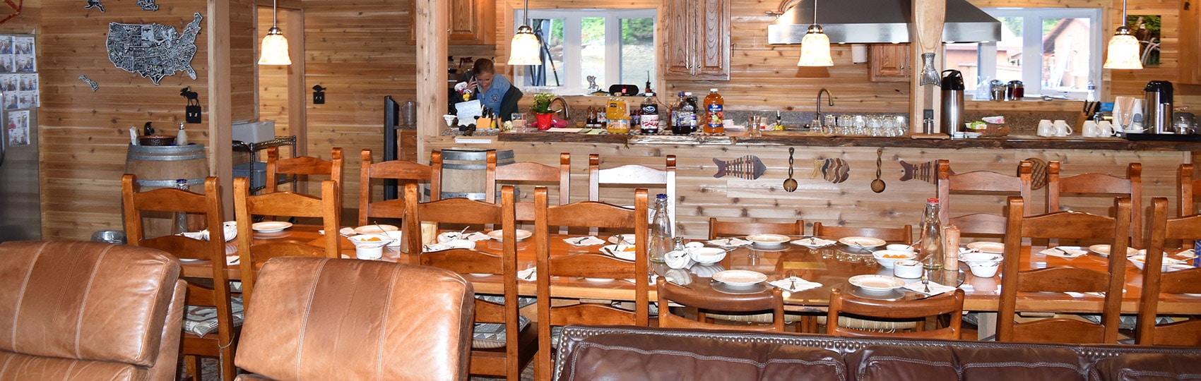 Long dining table and kitchen at the lodge.