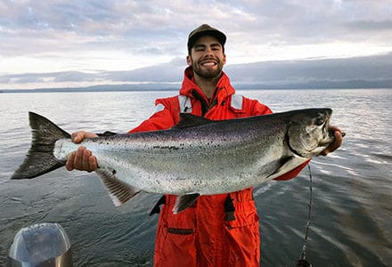 Guest holds large king salmon.