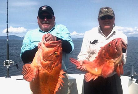 Two guests hold their large yelloweye rockfish.