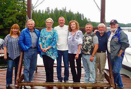Group of guests pose for the camera on the lodge dock.