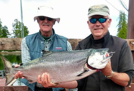 Two guests show off their king salmon.