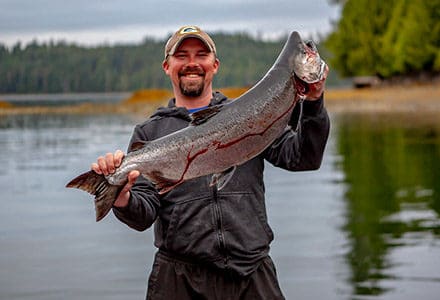 Guest holds up a beautiful king salmon.