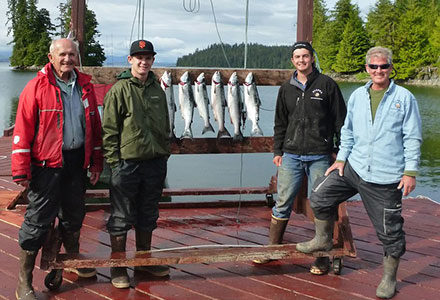 Four guests pose with their salmon catch of the day.