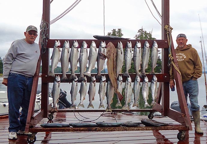 Guests pose with their silver salmon and ling cod catch.