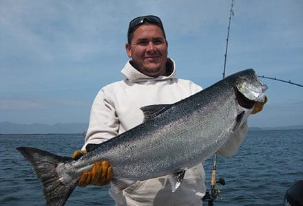 Crewmember takes a break and shows off his king salmon.