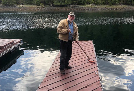 Tim refinishes a dock at the lodge.